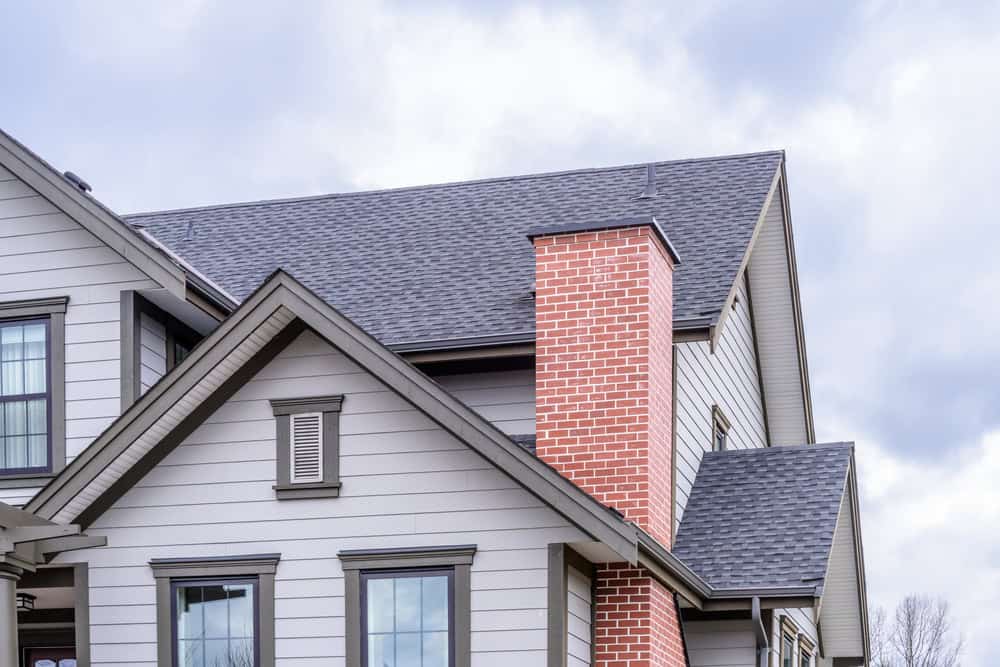 View from the top of an apartment building, with a well-maintained chimney in focus, emphasizing Suburban Chimney Solutions' commitment to professional chimney services.